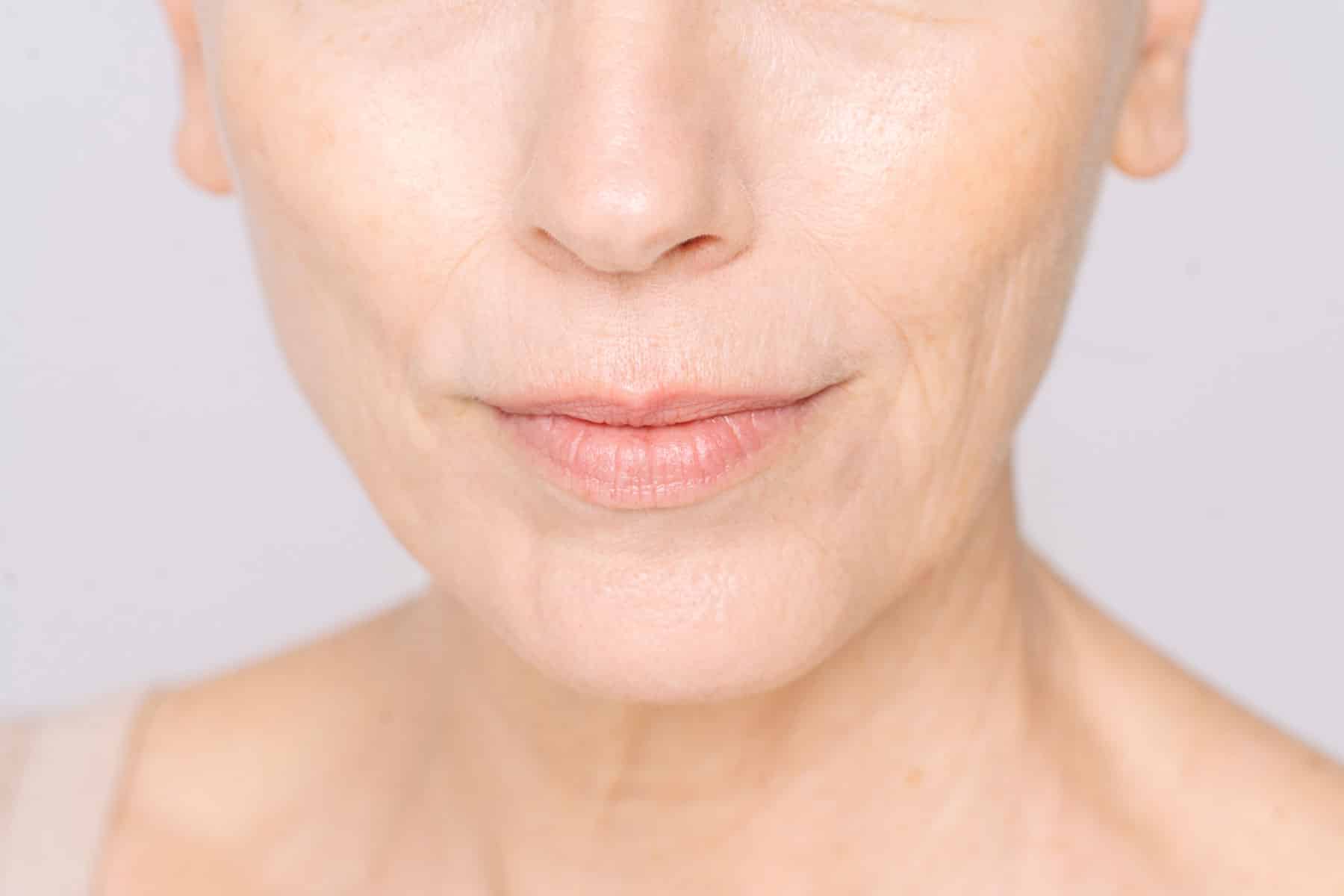 Older woman's lower face, close up shot with white complexion and smooth skin